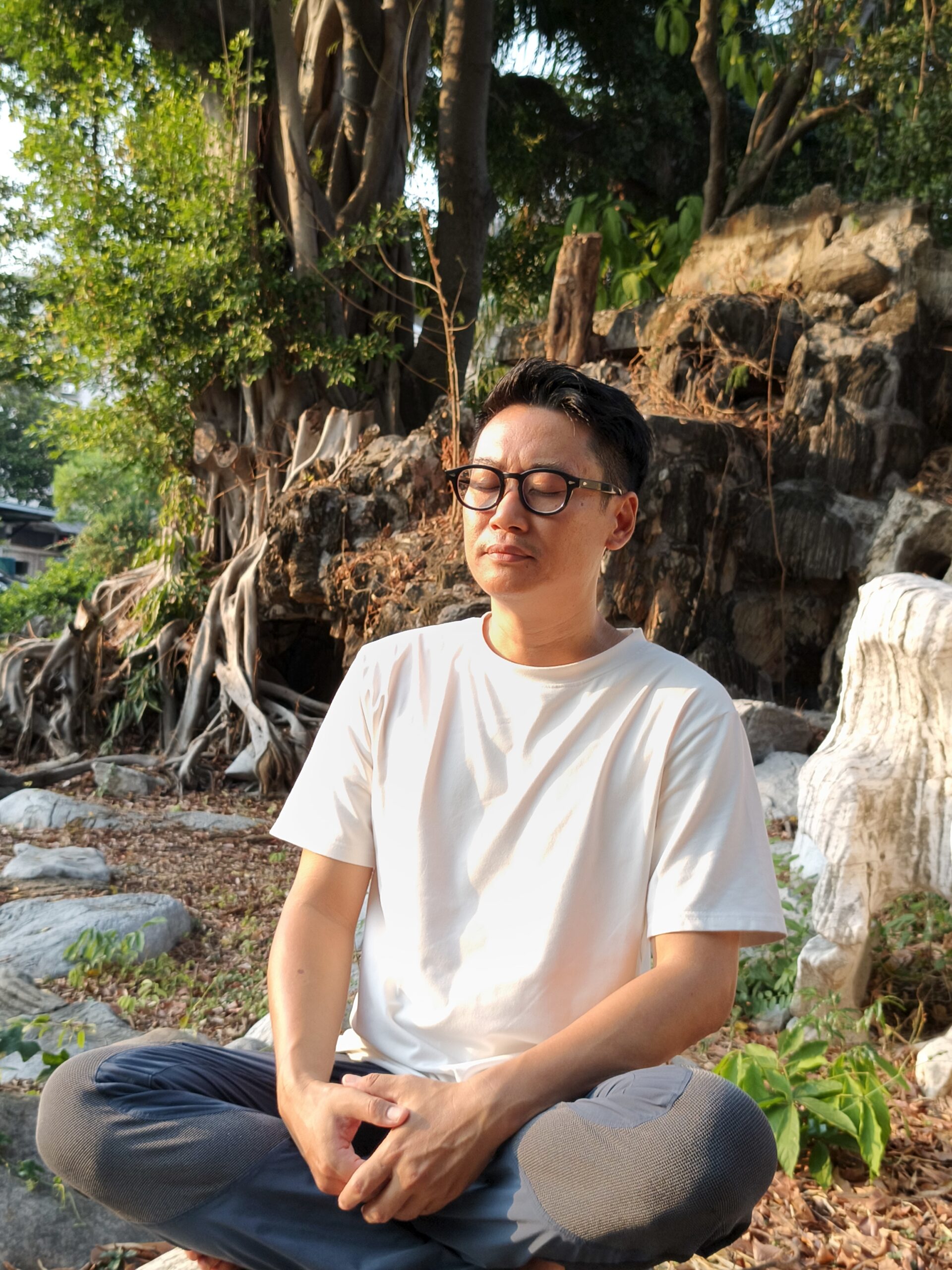 A man sits outside in nature and meditate