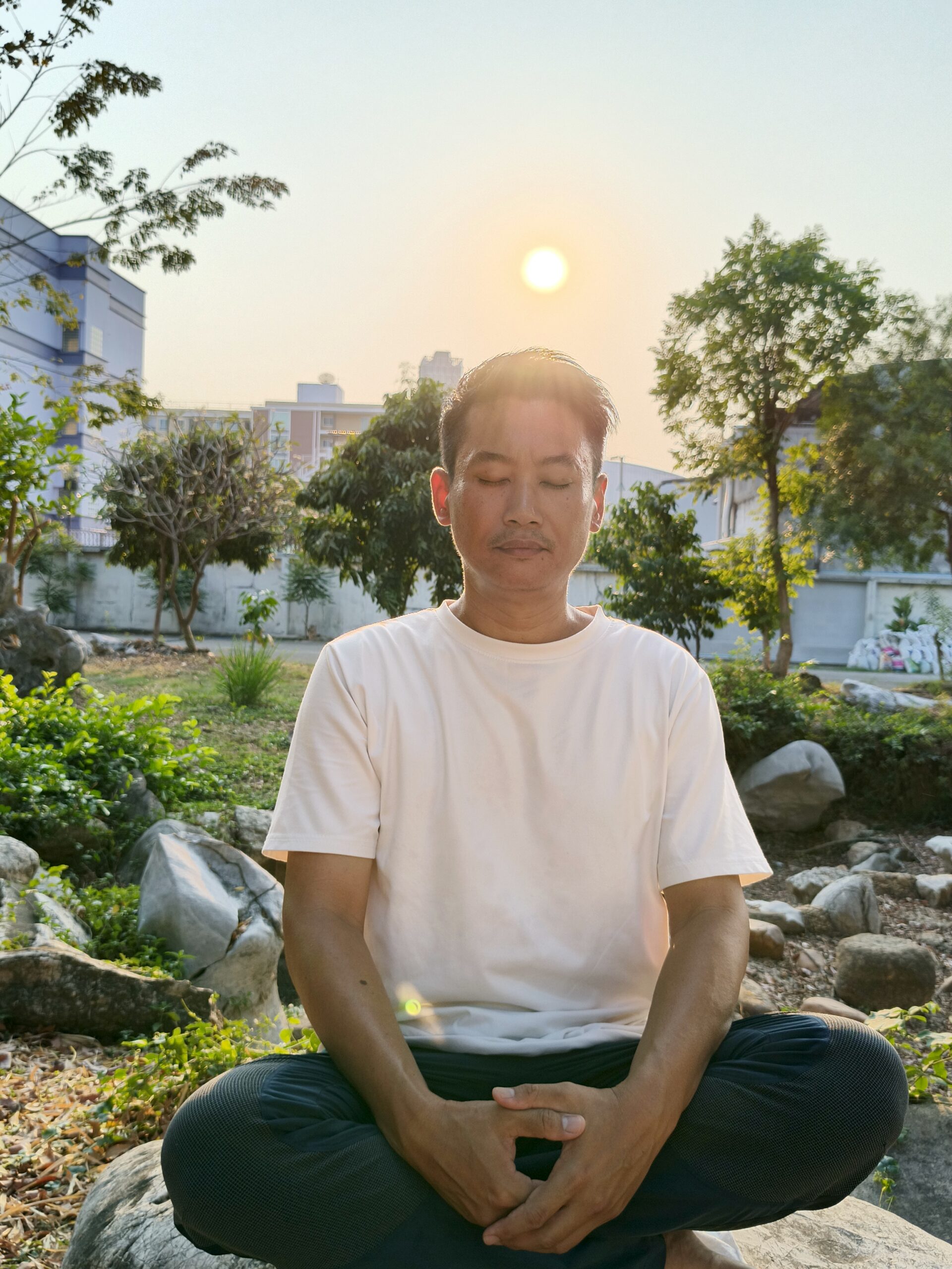 A man meditate outside during sunset